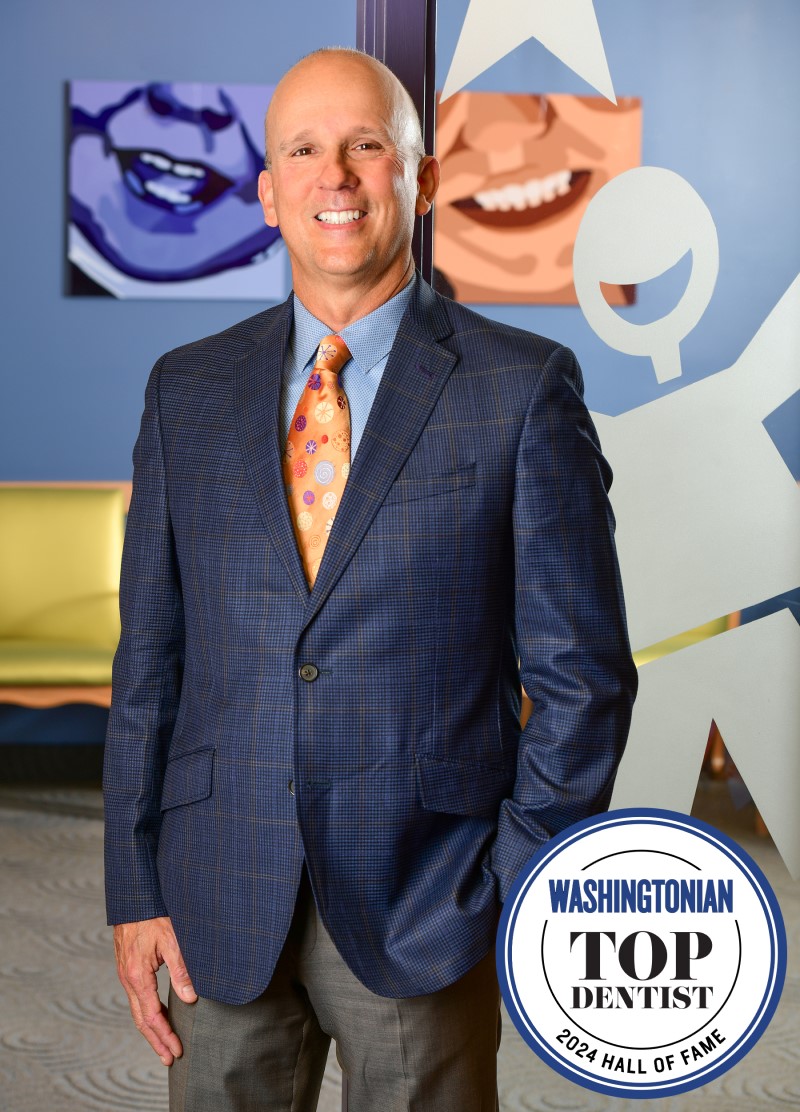 A portrait of board certified pediatric dentist Dr. Ricardo Perez with a "Washingtonian Top Dentist 2024 Hall of Fame" badge